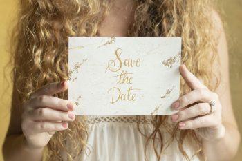 Woman holding a save the date wedding invitation