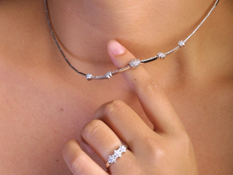 Woman shows off her jewelry suitable for her active lifestyle while also taking time to understand the jewelry care necessary for her lifestyle.